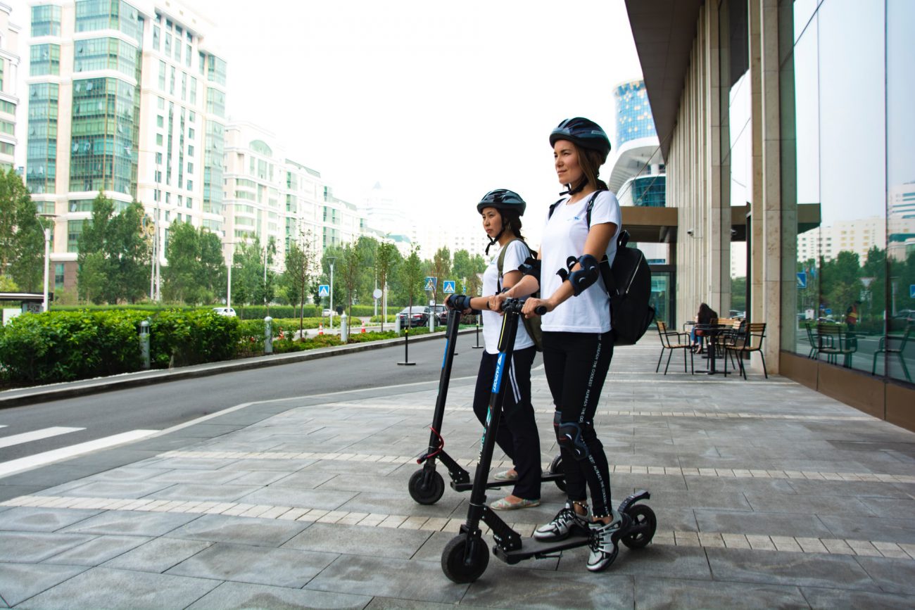 People riding electric scooters